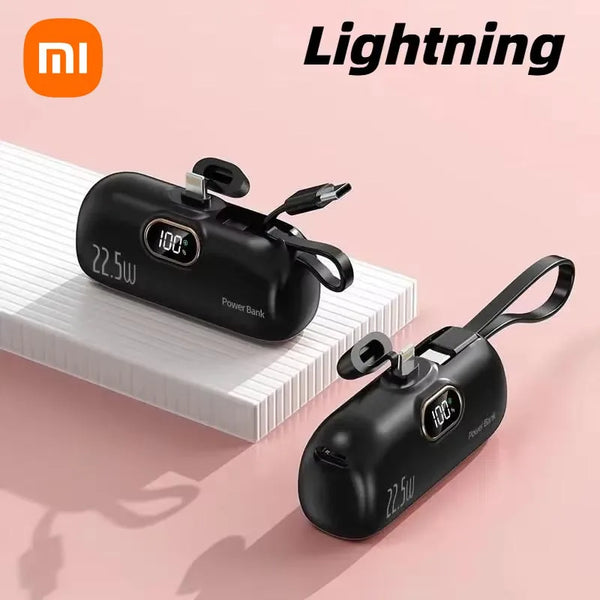 Two black power banks with digital displays on a pink background, featuring the Xiaomi logo.